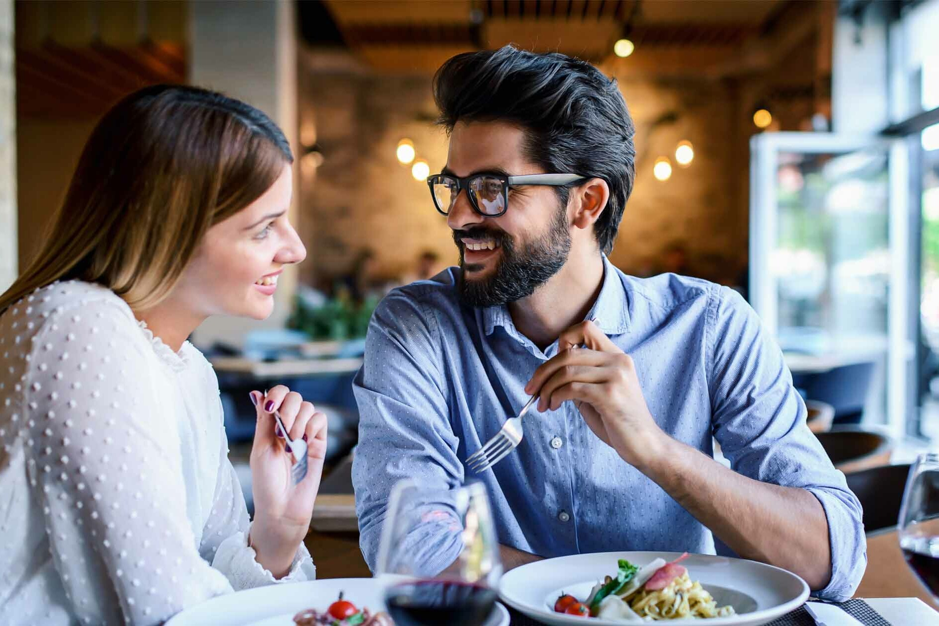 Couple Leans in Over Dinner - Decoding Body Language