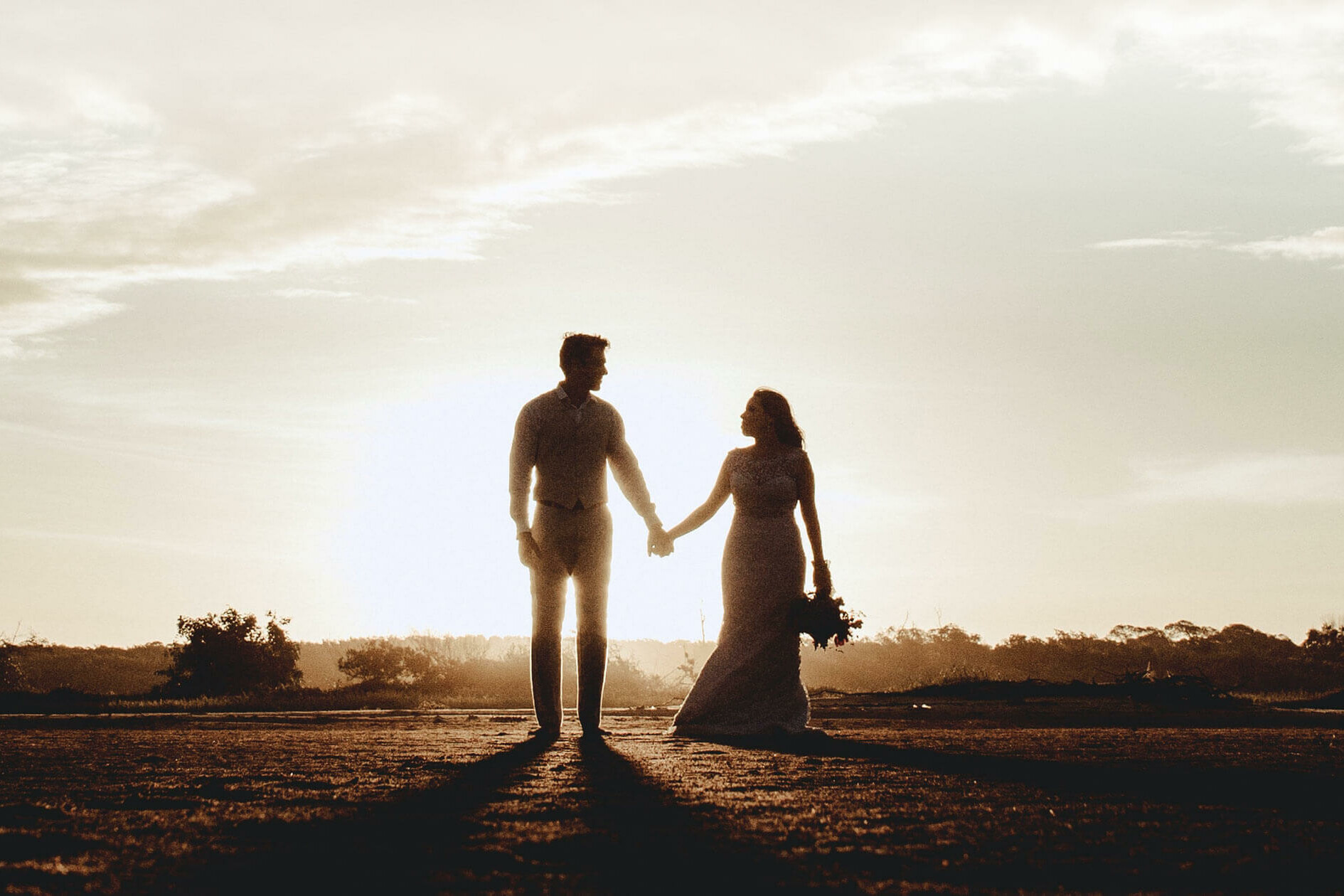 couple walking into sunset