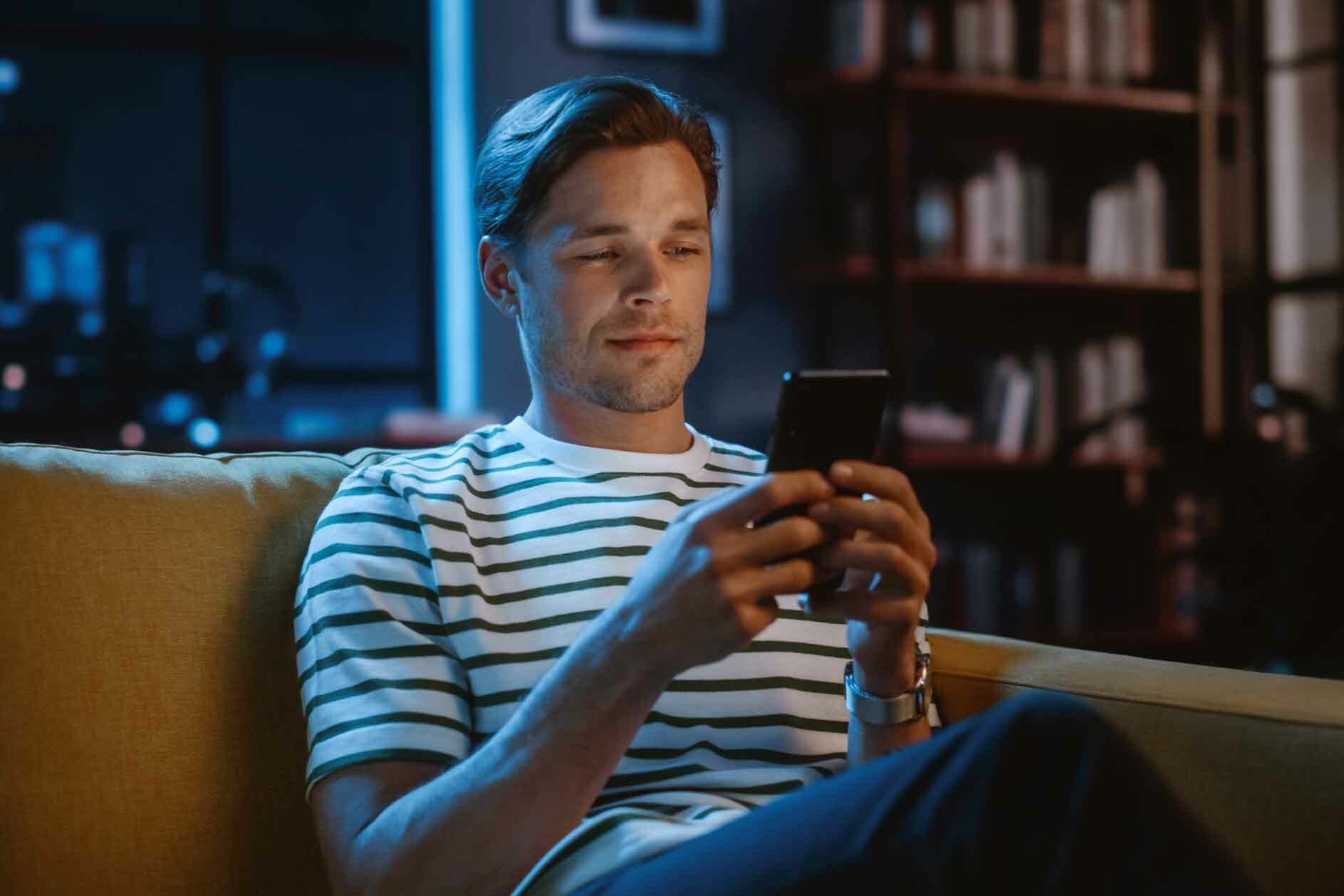 man texting smiling
